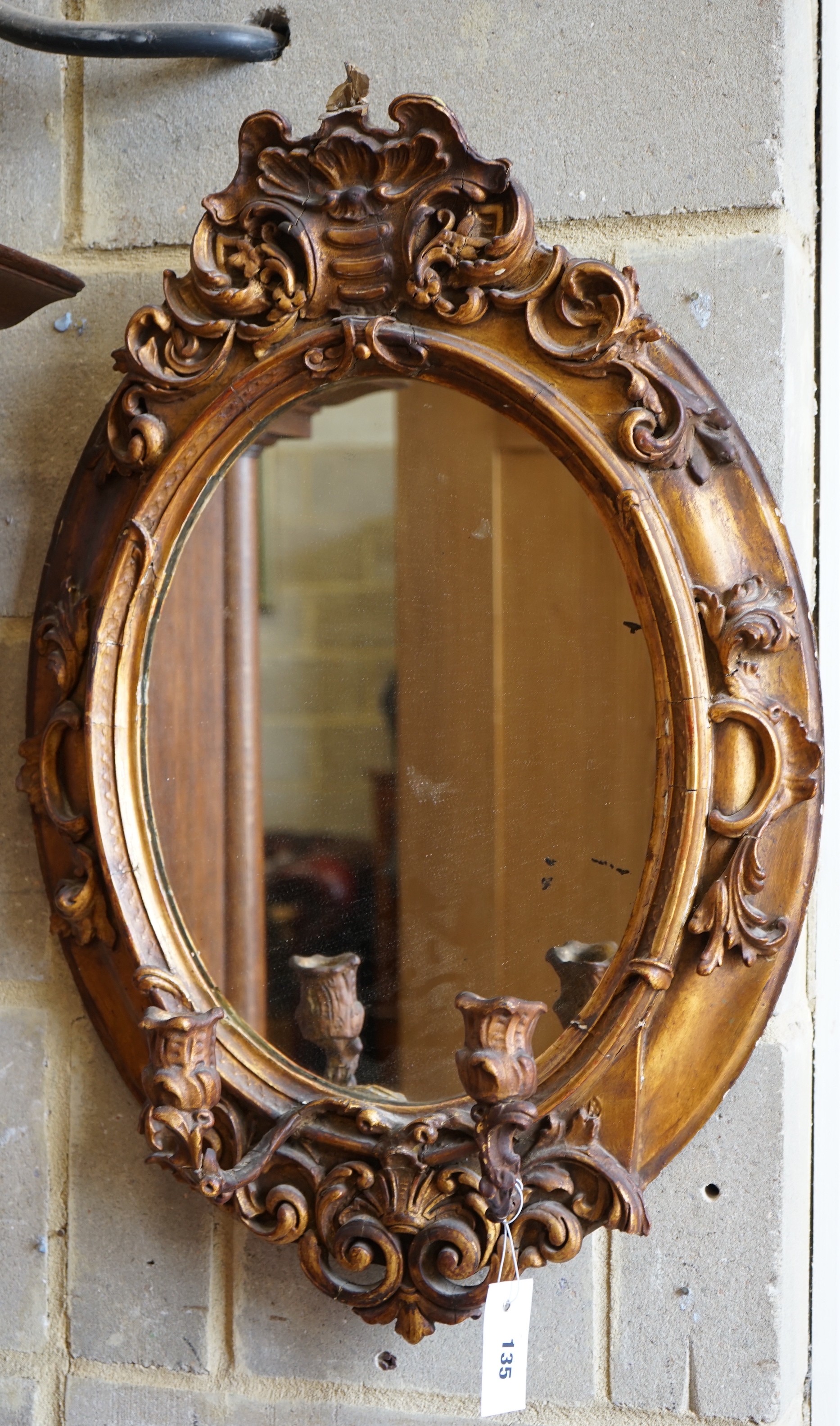 A Victorian giltwood and gesso oval girandole, width 48cm, height 72cm